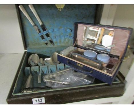 A part canteen of cutlery and a vintage vanity case