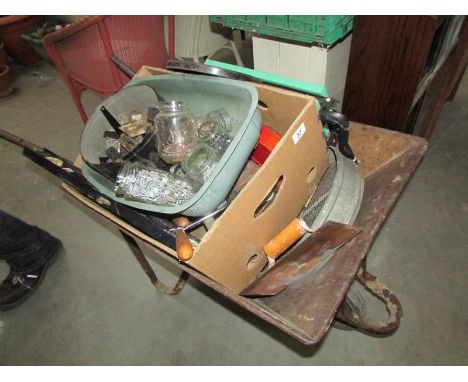 A wheel barrow and tools etc