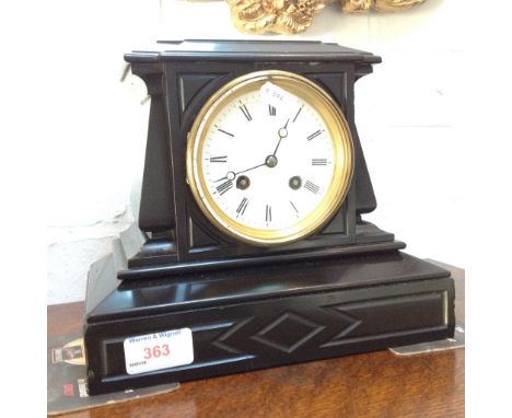 A SMALL BLACK SLATE MANTEL CLOCK WITH ENAMEL DIAL