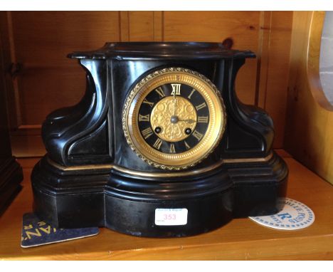 A BLACK SLATE MANTLE CLOCK WITH GILDED DIAL