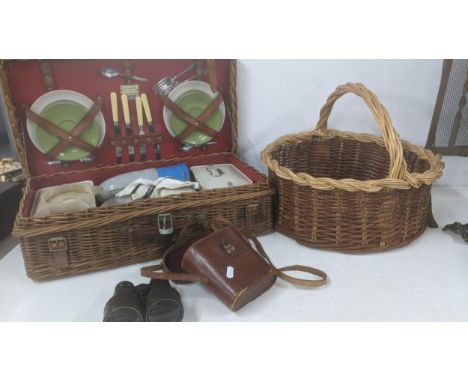 A mixed lot to include a coracle Harrods London, a pair of vintage binoculars, and a two tone wicker basket, along with a Col