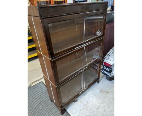 A mid-20th century mahogany veneered Globe Wernicke style bookcase with three glass up-and-over doors 126cm h x 87cm w Locati