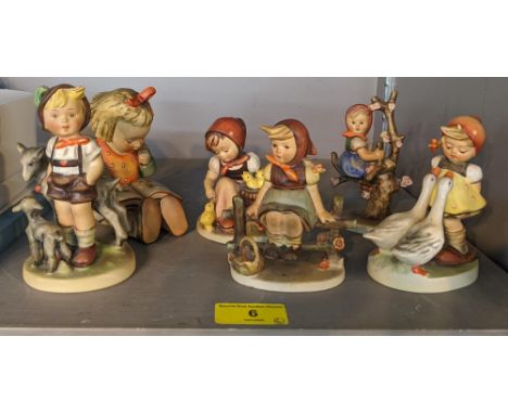 Six Hummel Goebel figures to include a young girl sitting on a fence, another reading a book, a girl with two geese, and othe
