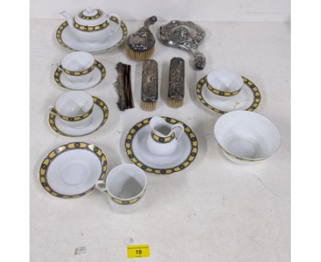 A silver plated dressing table set comprising of a mirror, two brushes and a comb, part Slovakian tea set decorated with a ye