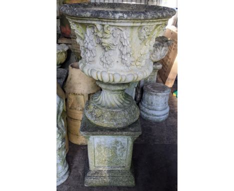 A garden stoneware urn shaped planter, moulded with flowers and with a wrythen base, 99.5cm h x 52cmwLocation:If there is no 