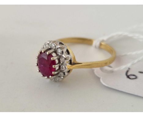 A ruby and diamond oval cluster ring 18ct gold size R