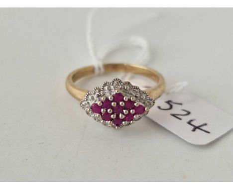 A lozenge shaped ruby and diamond cluster ring 9ct size P
