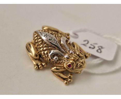 A frog brooch set with diamonds and ruby eyes, 9ct, 7.7 g
