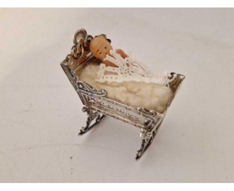 A miniature Cot (Dutch) with chased decoration, 2.5" long