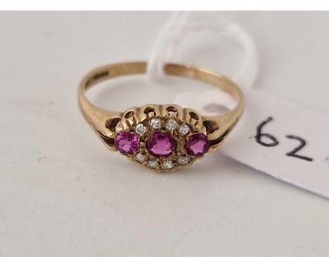 A diamond and ruby boat shaped ring 9ct size N