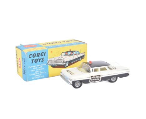 A vintage Corgi Toys boxed diecast model No. 481 Chevrolet Police Car with driver and passenger figures and a sprung suspensi