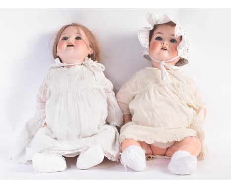 Two early 20th Century German ( Heubach Koppelsdorf ) bisque headed dolls. Both having blue flirty eyes, finely painted brows