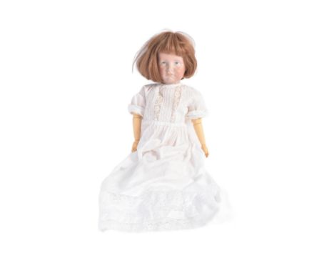 An early 20th Century German ' Kammer &amp; Reinhardt ' bisque headed doll with a replacement composition body. Painted blue 