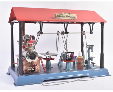 An original Wilesco D141 live steam engine workshop. Horizontal steam engine with pressure gauge, single cylinder and brick e