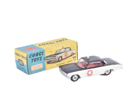 A vintage Corgi Toys diecast model No. 237 Oldsmobile ' Sheriff ' Car with sprung suspension, red interior and County Sheriff