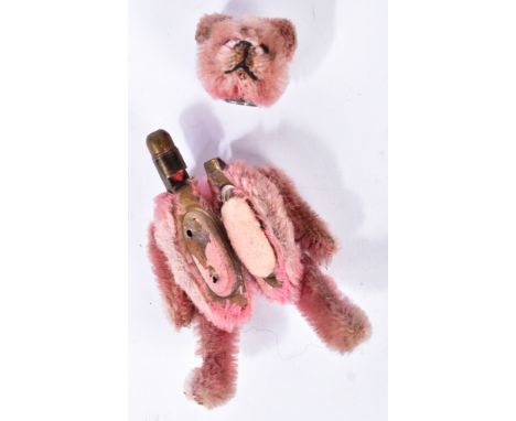 An early 20th Century circa 1930s Schuco teddy bear compact. Pink mohair, pin eyes, stitched nose and mouth with a metal fram