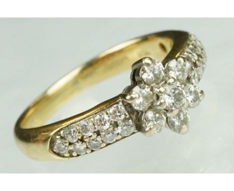 Diamond flower head 18ct yellow gold ring, the centre round brilliant cut diamond weighing approx 0.10 carat, the six round b