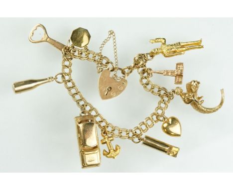 9ct gold vintage charm bracelet. The bracelet having a double curb link bracelet chain, heart padlock clasp and ten charms. A