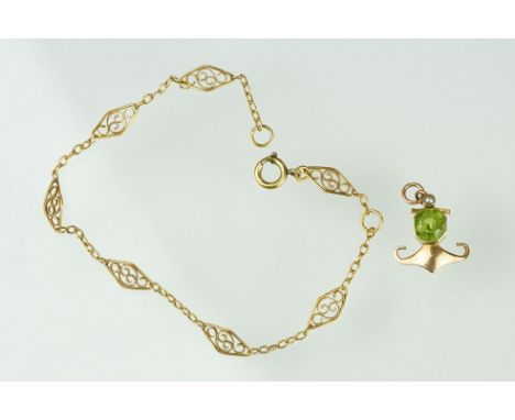 Edwardian 15ct gold peridot and pearl pendant together with a yellow metal filigree bracelet with spring ring clasp. Pendant 