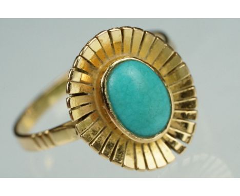 Turquoise yellow metal sunburst ring, oval cabochon turquoise stone, dimensions approx 8.5mm x 6mm, rubover set, tapered star