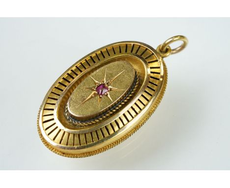 19th century ruby oval pendant, the openwork oval design with small ruby to centre, gypsy set, rope twist border, pierced sur