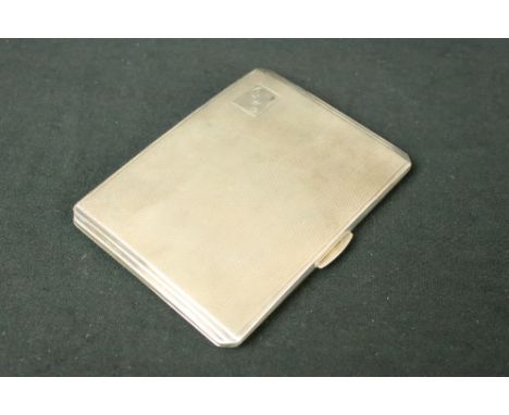 Silver hallmarked cigarette case having an engine turned exterior with initial panel to the corner. Hallmarked Smith Bartlam,