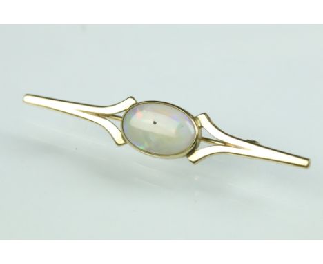 Opal 9ct yellow gold bar brooch, the oval cabochon precious white opal measuring approx 14mm x 9mm, rubover set, displaying v