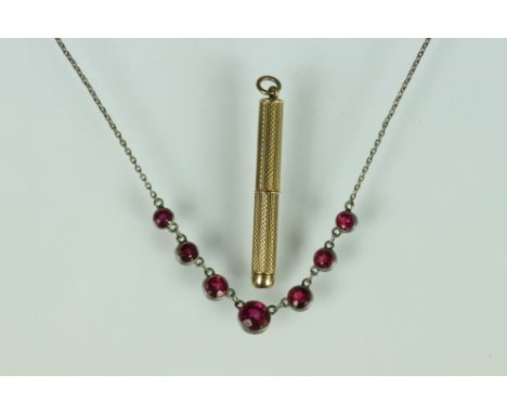 9ct gold cased retractable toothpick (toothpick deficient) together with an early 20th century synthetic ruby white metal riv