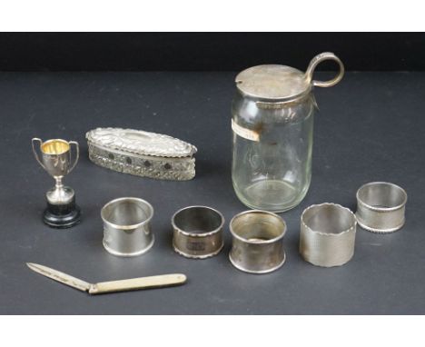 Five various silver napkin rings; a silver topped preserve pot, makers Haseler &amp; Bill, Chester 1922; a silver topped dres