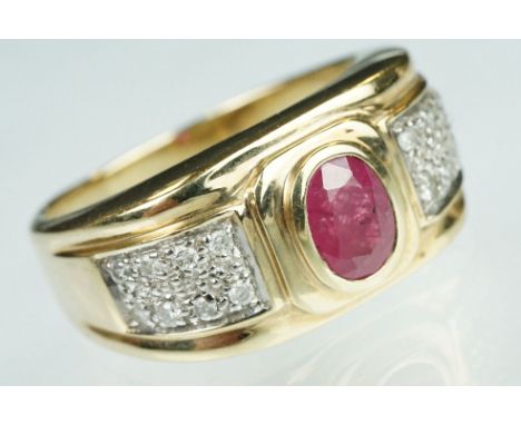 Ruby and diamond 9ct yellow gold ring, oval mixed cut ruby measuring approx 7mm x 5mm, rubover set, eight small round brillia