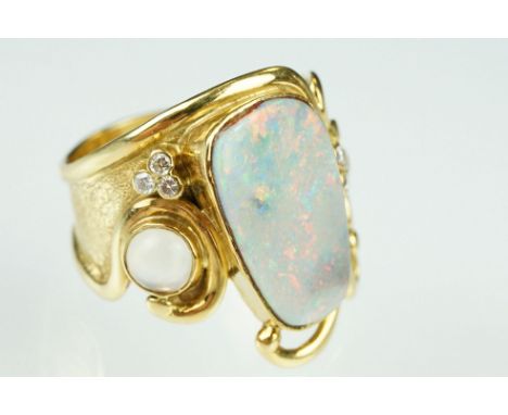 Opal, moonstone and diamond 18ct yellow gold ring, the precious white opal displaying indigo, blue, yellow, green, orange and