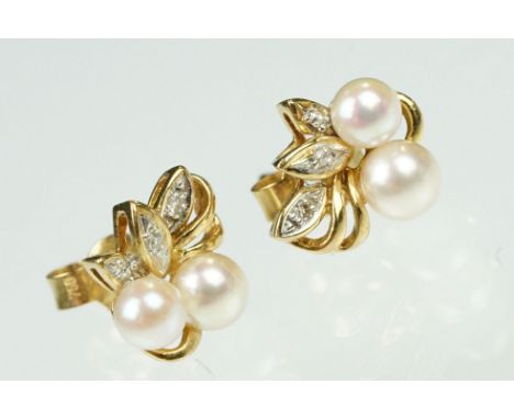 Pair of cultured pearl and diamond yellow metal stud earrings, two cream cultured pearls with pink overtones to each earring,