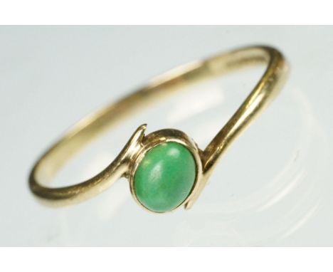 Turquoise 9ct yellow gold crossover ring, the oval cabochon cut turquoise measuring approx 5mm x 3.5mm, rubover set, crossove