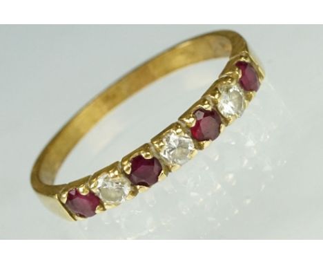 Ruby and diamond 18ct yellow gold ring, four small round cut rubies, three small round brilliant cut diamonds, claw settings,