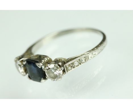 Diamond and sapphire platinum three stone ring, the central truncated rectangular cut sapphire measuring approx 6 x 5 x 2.5mm