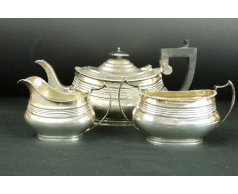 Three piece silver tea service comprising teapot, milk jug and twin handled sugar bowl, gadrooned border, ribbed and moulded 