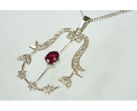 Ruby and diamond 18ct white gold pendant necklace, the central oval mixed cut ruby measuring approx 5mm x 4mm, claw set, smal