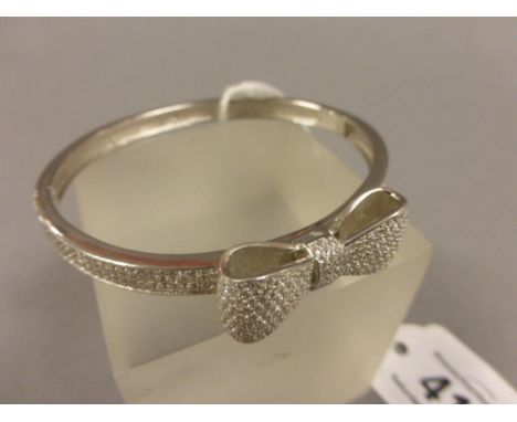 Silver and CZ bangle in the shape of a bow