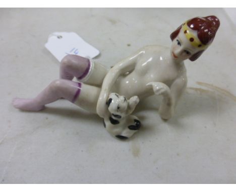 Ceramic Art Deco style figure of a lady playing with her dog