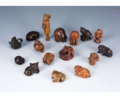 Group of carved wood netsukesJapanese, including a clam shell with carved figures, various animals, skeleton and others, (15)