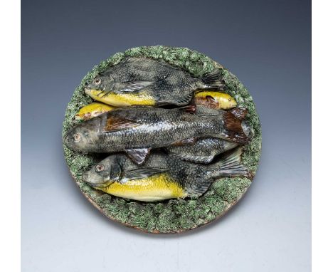 Palissy revival circular platePortuguese, late 19th Century, with a platter of fish resting on a mossy ground, impressed mark