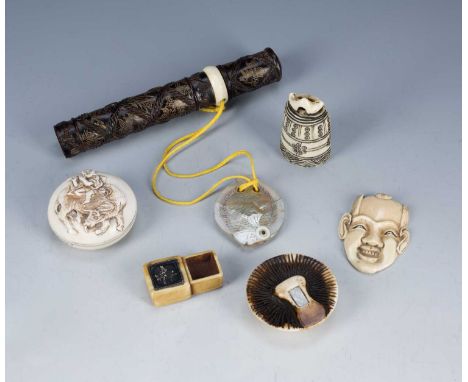 Group of netsukes and other piecesJapanese, including an ivory manju, an inlaid wood and ivory cylindrical case, with mother 