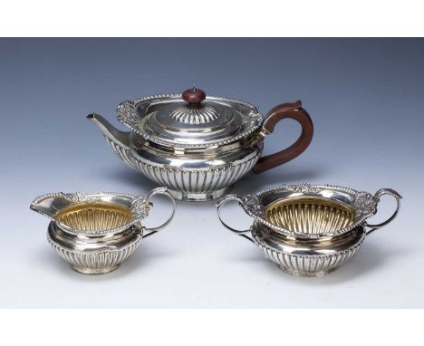 Three-piece Victorian silver tea set consisting of a squat teapot, twin handled sucrier and milk/cream jug, bearing marks for