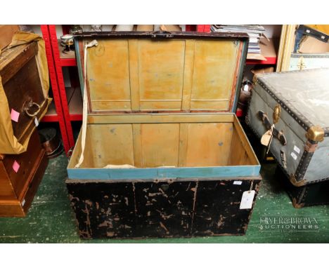 A large metal travelling trunk, black painted finish