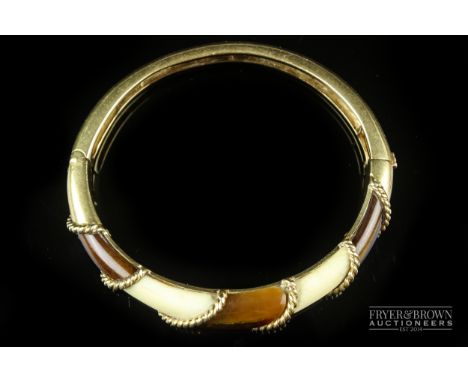 A Van Cleef &amp; Arples 18ct gold, tiger's eye and bone bangle, c1970, the rope twist bangle signed VCA and numbered 2176E3