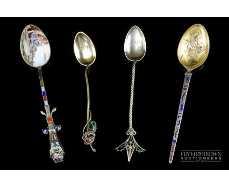 Egyptian interest - an 800 standard silver collector's spoon, the finial cast as a hinged sarcophagus, the bowl with landscap