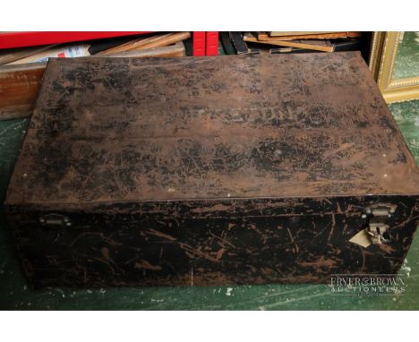A vintage metal storage trunk, the interior of the lid marked 57863