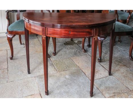 A mahogany demi-lune fold over card table with single drawer, inlaid boxwood stringing, on square slender tapering legs, c190