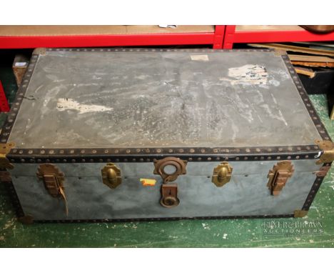 A grey composition travelling trunk, with red gingham interior