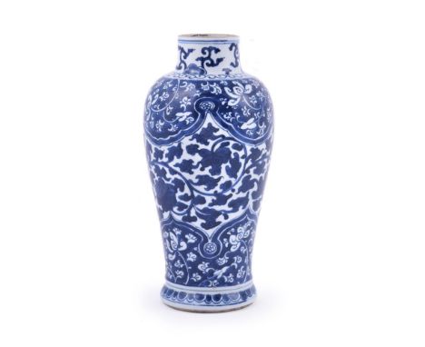 A Chinese blue and white vase, Kangxi, brightly painted in blue with a central panel of scrolling foliage between lappet bord